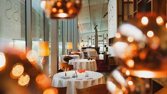 the view inside the restaurant of the BMW Welt with tables and decorations the view inside the restaurant of the BMW Welt with tables and decorations