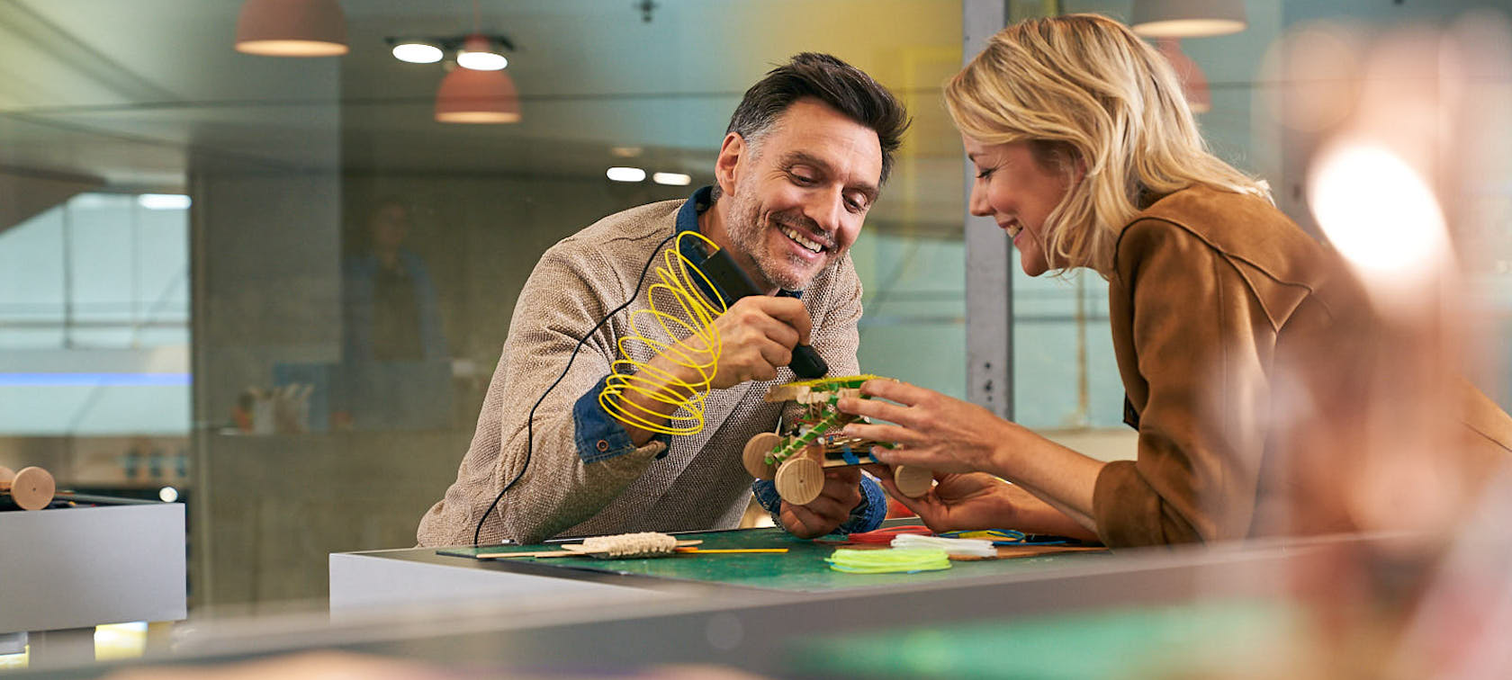 BMW Adult Workshop Man and woman tinkering together on a car model