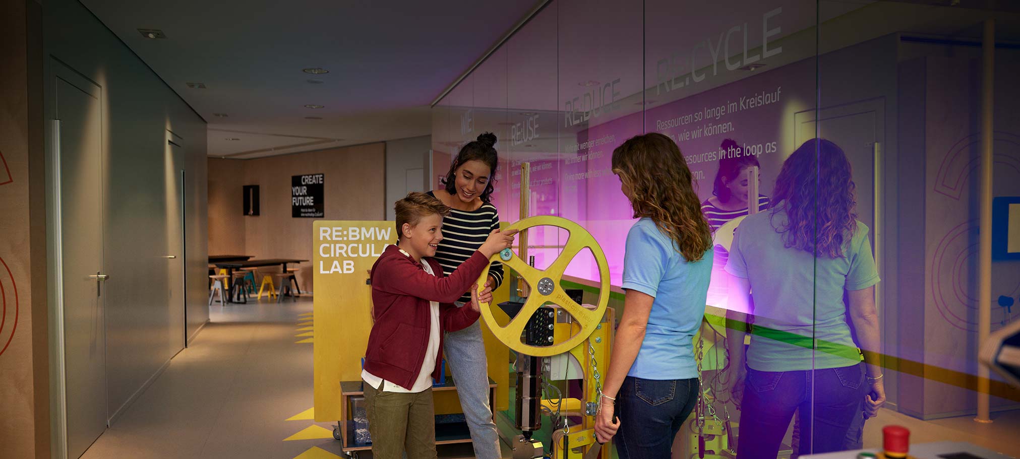 RE:BMW CIRCULAR LAB Workshops Child turns a wheel on a machine at the BMW sustainability workshop